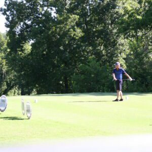 A man is playing golf on the green